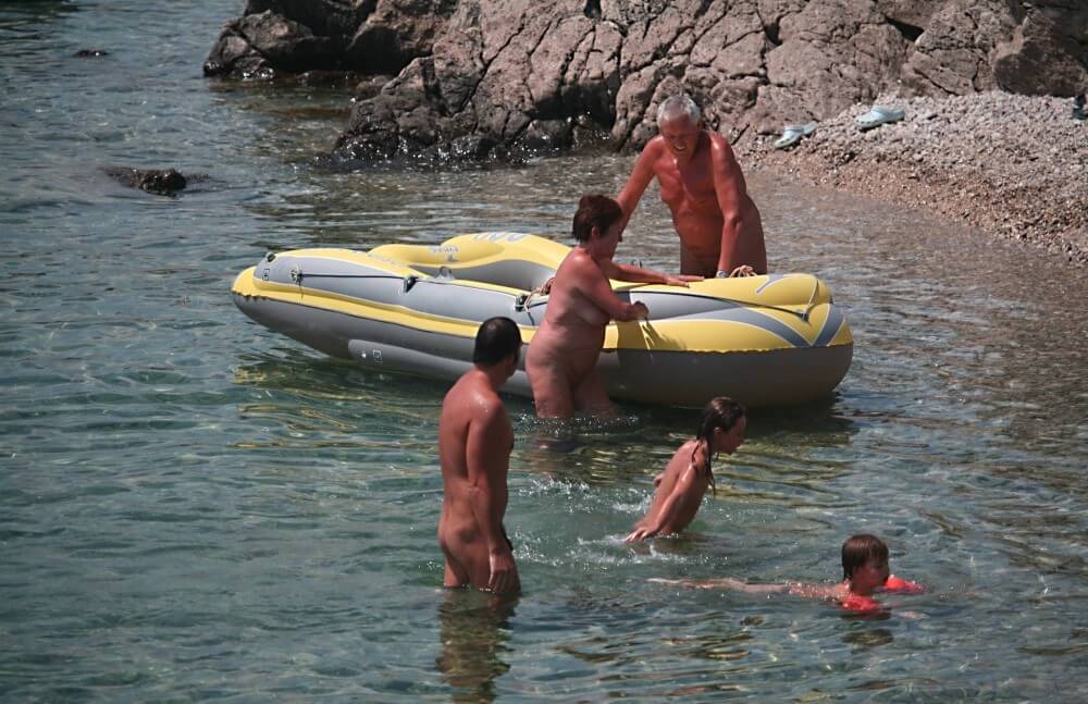 Lone Nudist in Yellow Boat photos - It is a path to inner freedom, achieved through acceptance and openness without clothing